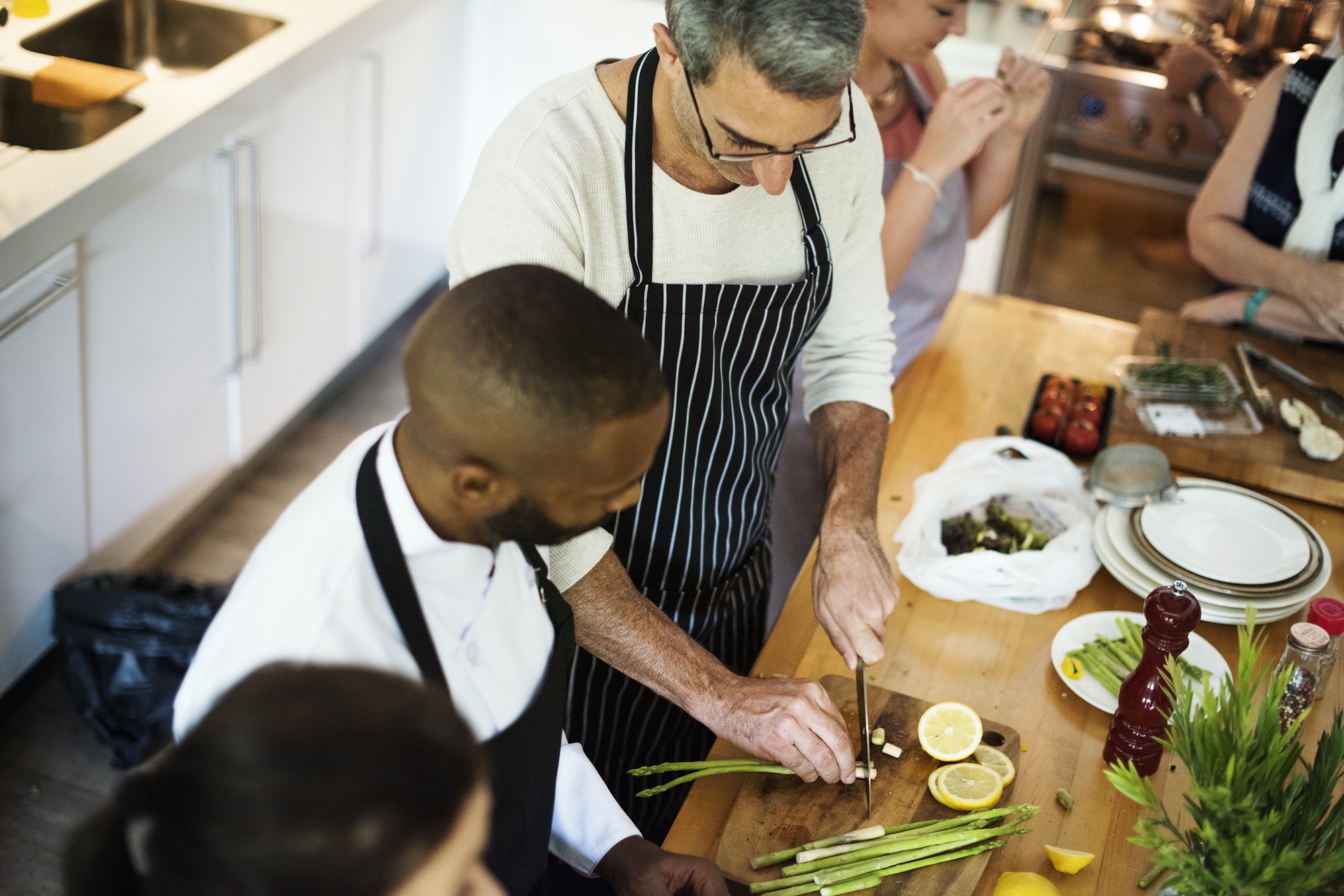 Open kitchen scene with chef and trainees